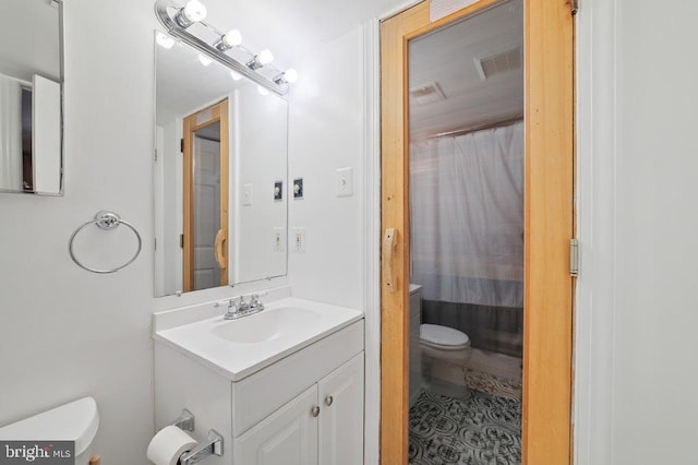 bathroom featuring vanity and toilet