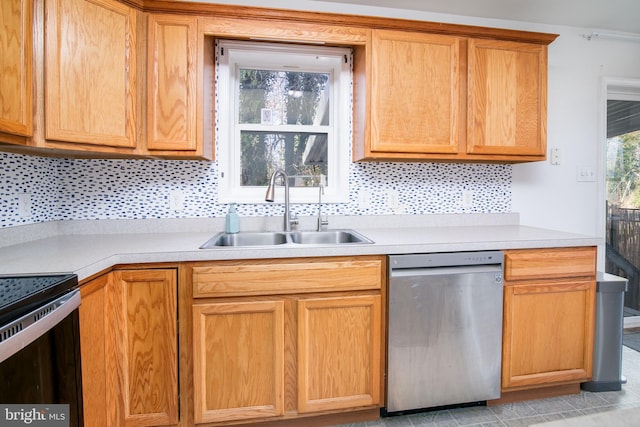 kitchen with backsplash, stainless steel dishwasher, black / electric stove, and sink