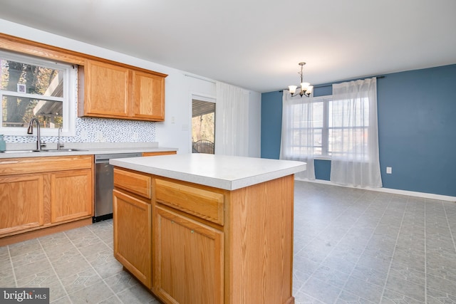 kitchen featuring sink, decorative light fixtures, dishwasher, a center island, and a chandelier