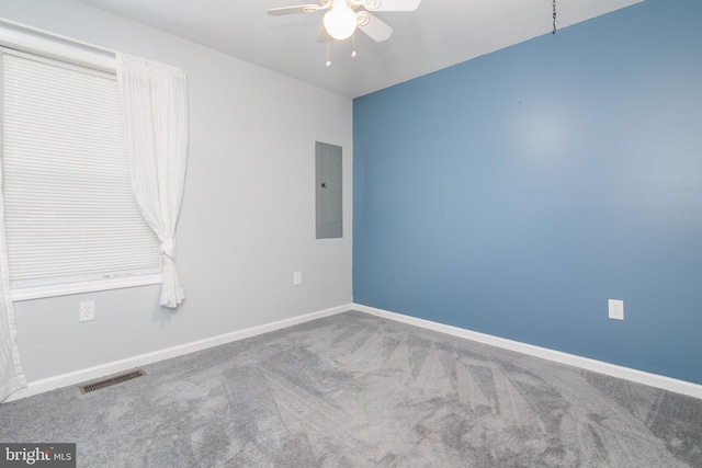 spare room featuring carpet floors, electric panel, and ceiling fan