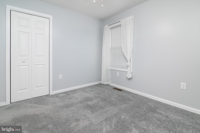 unfurnished bedroom with carpet floors and a closet