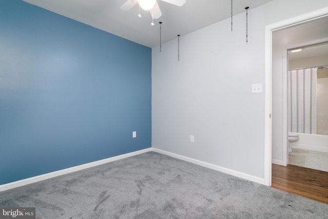 carpeted spare room with ceiling fan