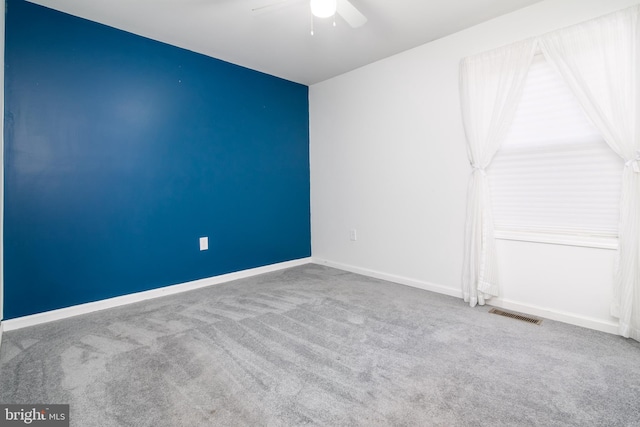 empty room with carpet flooring and ceiling fan