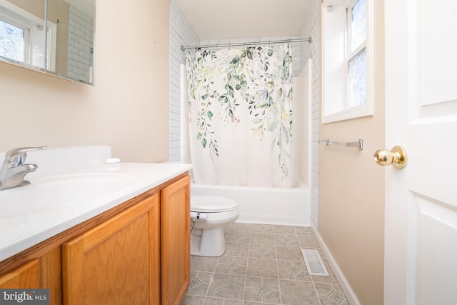 full bathroom with tile patterned floors, shower / bath combo with shower curtain, vanity, and toilet