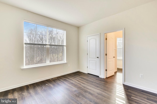 unfurnished bedroom featuring dark wood-type flooring