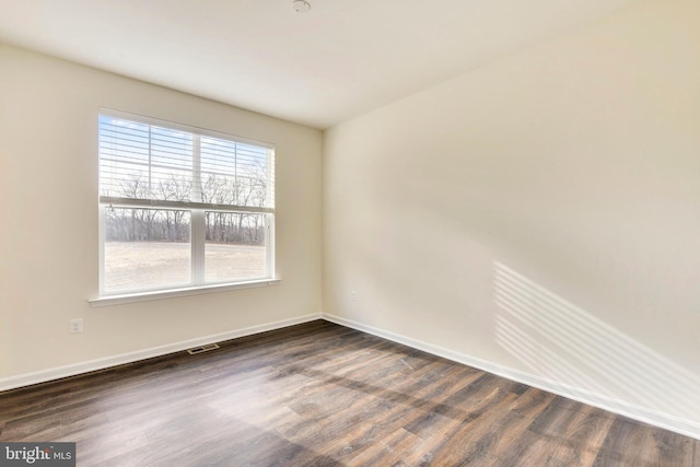 spare room featuring dark hardwood / wood-style floors