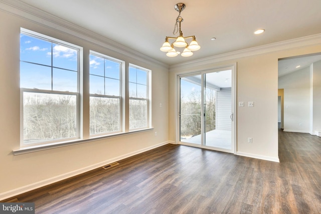 empty room with a chandelier, ornamental molding, and dark hardwood / wood-style floors