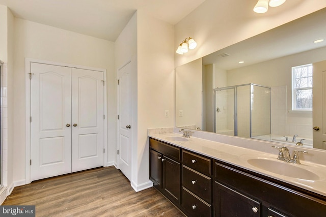 bathroom featuring vanity, an enclosed shower, and wood-type flooring