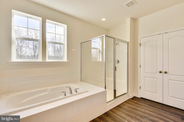 bathroom with hardwood / wood-style flooring and separate shower and tub