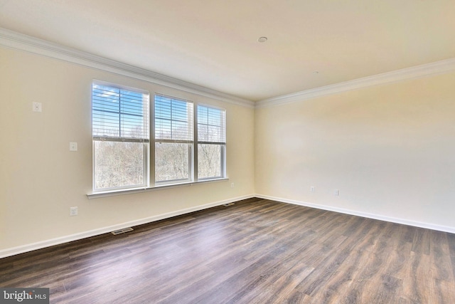 unfurnished room featuring dark wood-type flooring and ornamental molding