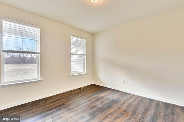 unfurnished room featuring dark hardwood / wood-style floors