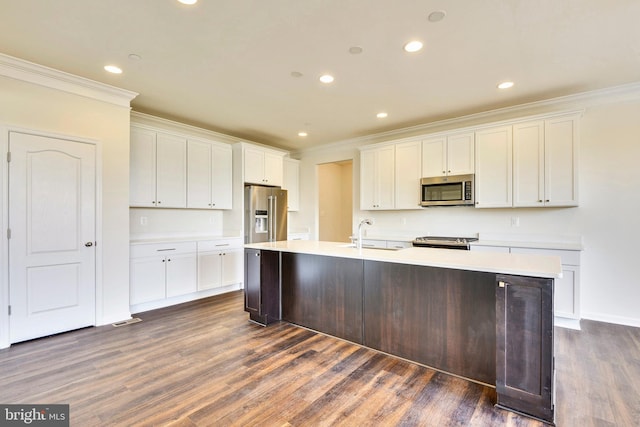 kitchen with white cabinetry, appliances with stainless steel finishes, dark hardwood / wood-style floors, and a kitchen island with sink