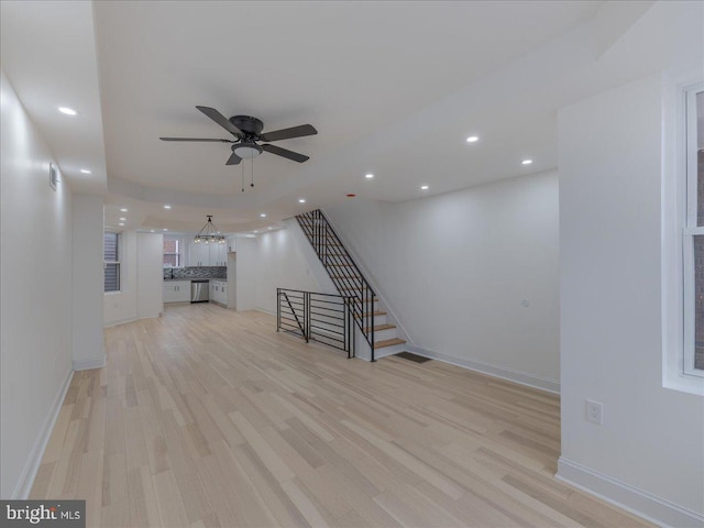 unfurnished living room with ceiling fan and light hardwood / wood-style flooring