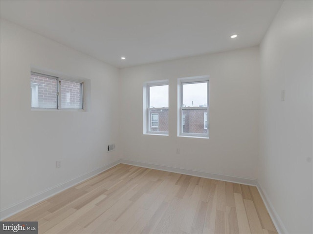 unfurnished room with light hardwood / wood-style flooring