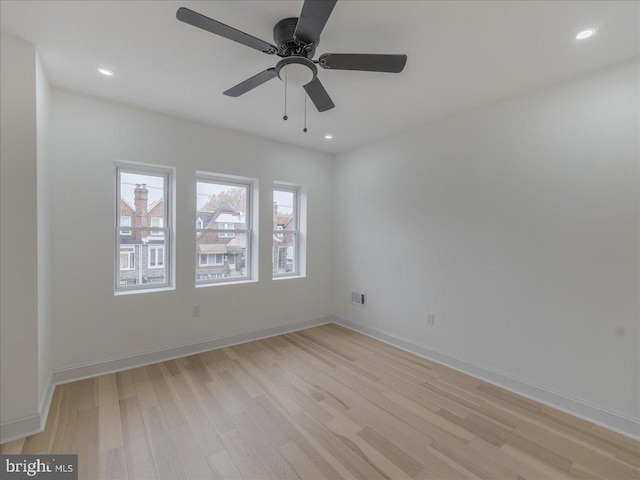 spare room featuring ceiling fan and light wood-type flooring