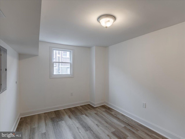 unfurnished room with light wood-type flooring