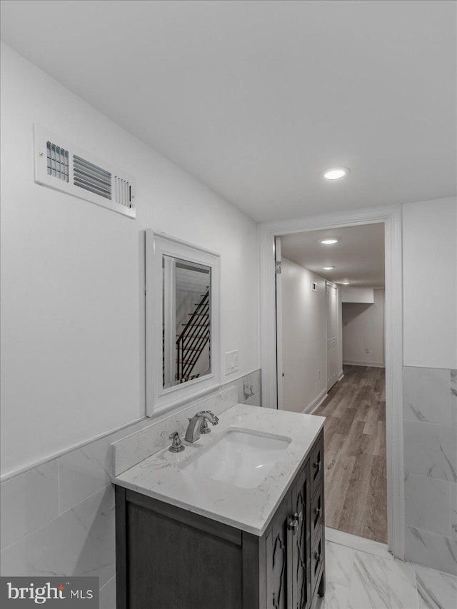 bathroom with hardwood / wood-style floors and vanity