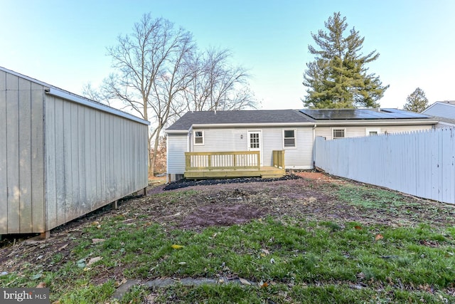 rear view of property featuring a wooden deck