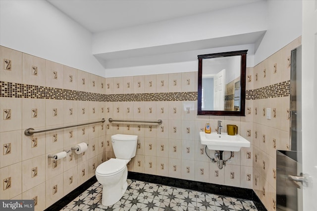 bathroom featuring toilet, tile walls, sink, and tile patterned floors