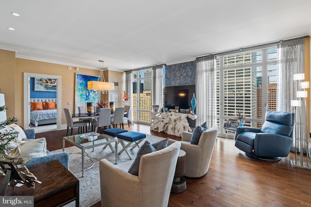 living room with ornamental molding, hardwood / wood-style flooring, floor to ceiling windows, and a healthy amount of sunlight