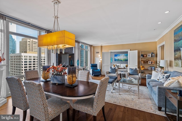 dining area featuring hardwood / wood-style flooring and crown molding