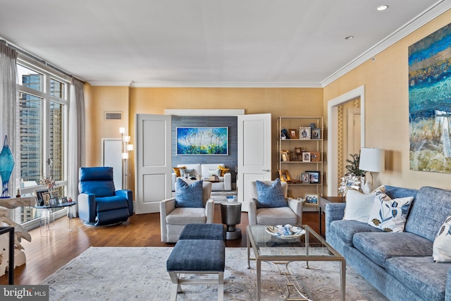 living room with hardwood / wood-style floors and ornamental molding