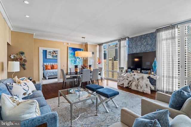 living room featuring a chandelier, hardwood / wood-style floors, and ornamental molding