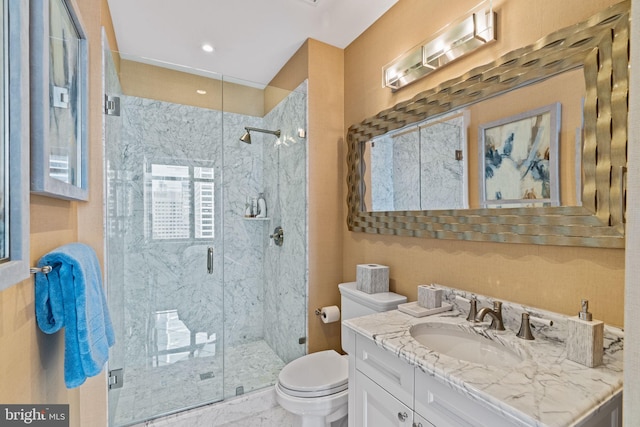 bathroom featuring vanity, toilet, and a shower with shower door