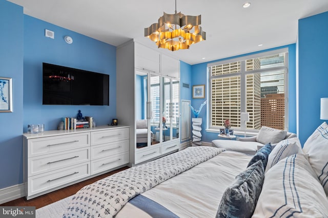 bedroom featuring dark hardwood / wood-style floors and a chandelier