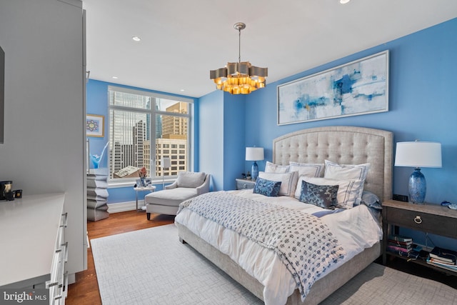 bedroom featuring hardwood / wood-style flooring and an inviting chandelier