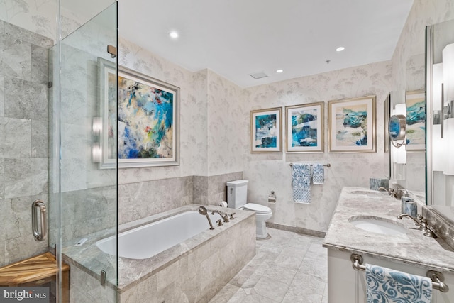 full bathroom featuring vanity, toilet, and tile walls