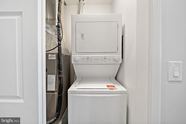 washroom featuring stacked washer and clothes dryer