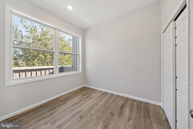 unfurnished bedroom featuring a closet and light wood-type flooring