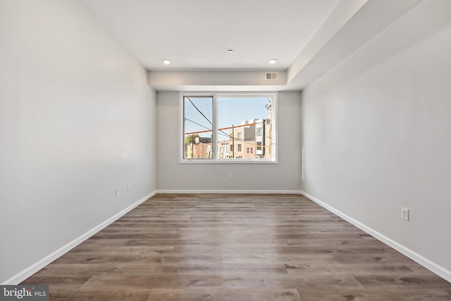 unfurnished room featuring dark wood-type flooring