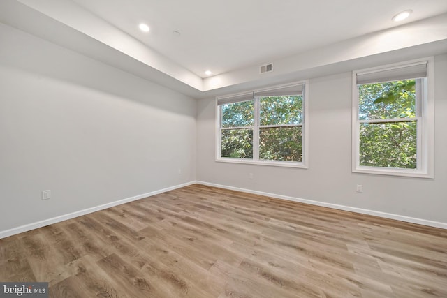 empty room with light hardwood / wood-style flooring