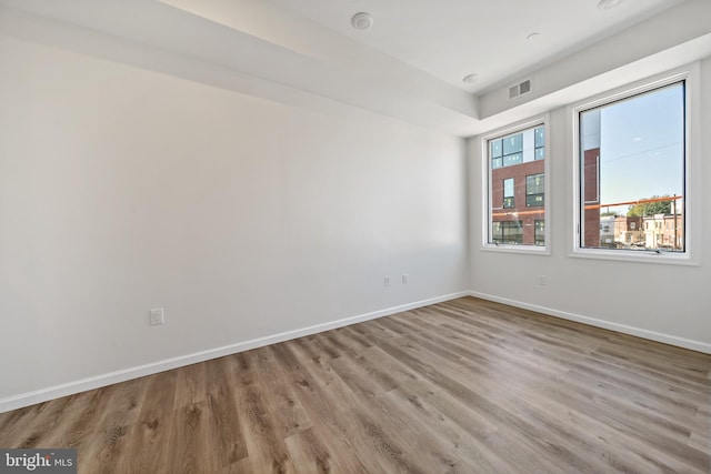 spare room with light hardwood / wood-style floors