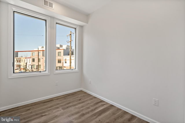 spare room with hardwood / wood-style floors