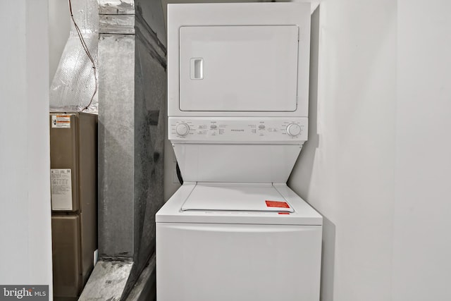 laundry room featuring stacked washer and clothes dryer