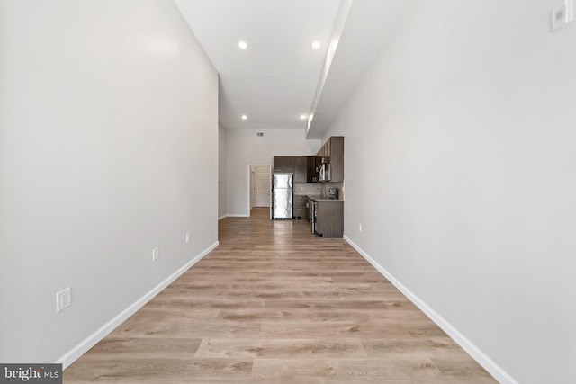 hall with light wood-type flooring