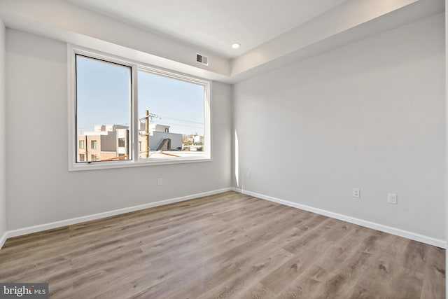 unfurnished room with light wood-type flooring