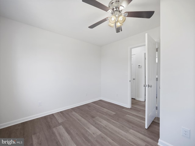 empty room featuring hardwood / wood-style flooring and ceiling fan