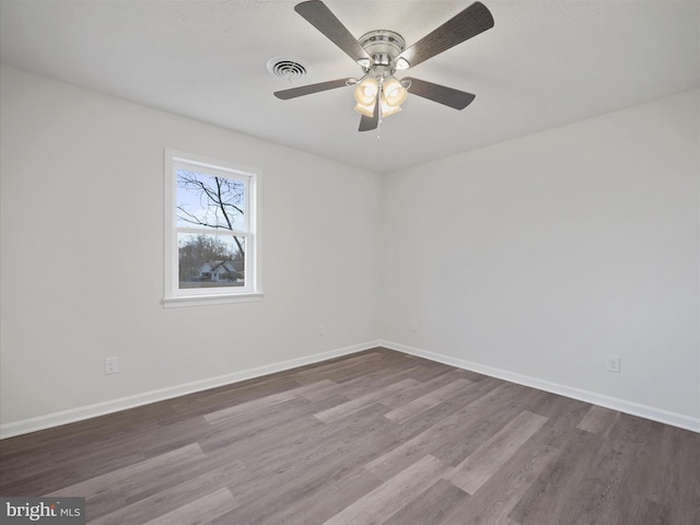 spare room featuring hardwood / wood-style flooring and ceiling fan