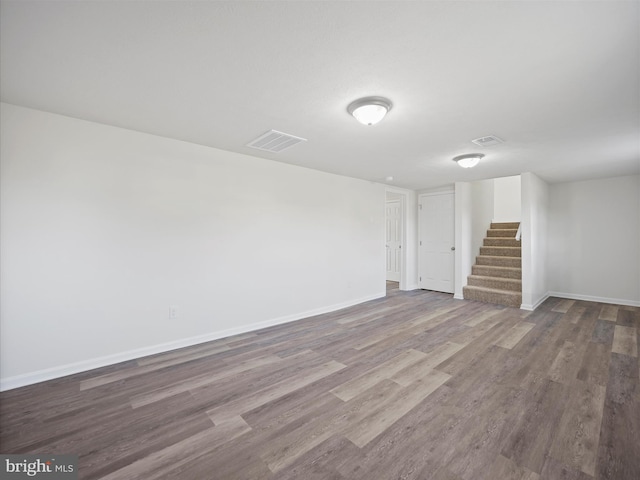 basement with hardwood / wood-style flooring