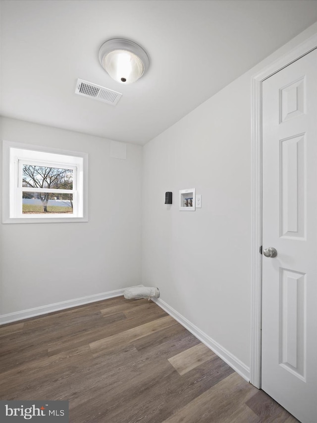 washroom featuring dark wood-type flooring and washer hookup