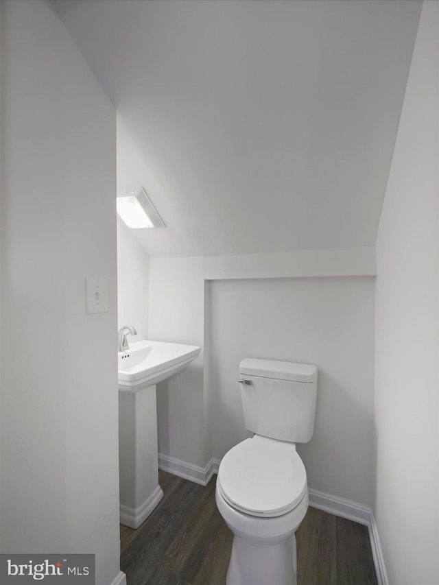 bathroom featuring hardwood / wood-style floors, toilet, and sink