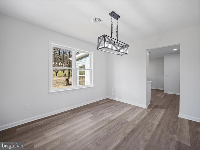 unfurnished dining area with wood-type flooring