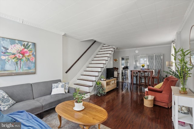 living room with dark wood-type flooring and ornamental molding