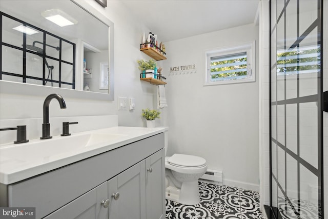 bathroom featuring tile patterned floors, vanity, toilet, and a baseboard heating unit