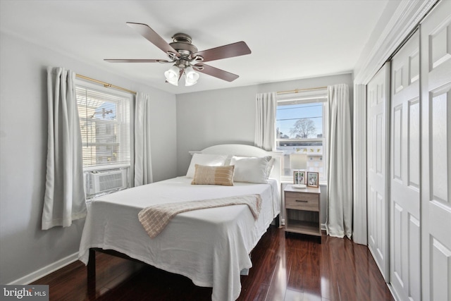 bedroom with a closet, cooling unit, ceiling fan, and dark hardwood / wood-style floors