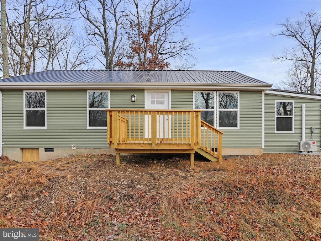 rear view of property featuring ac unit and a wooden deck